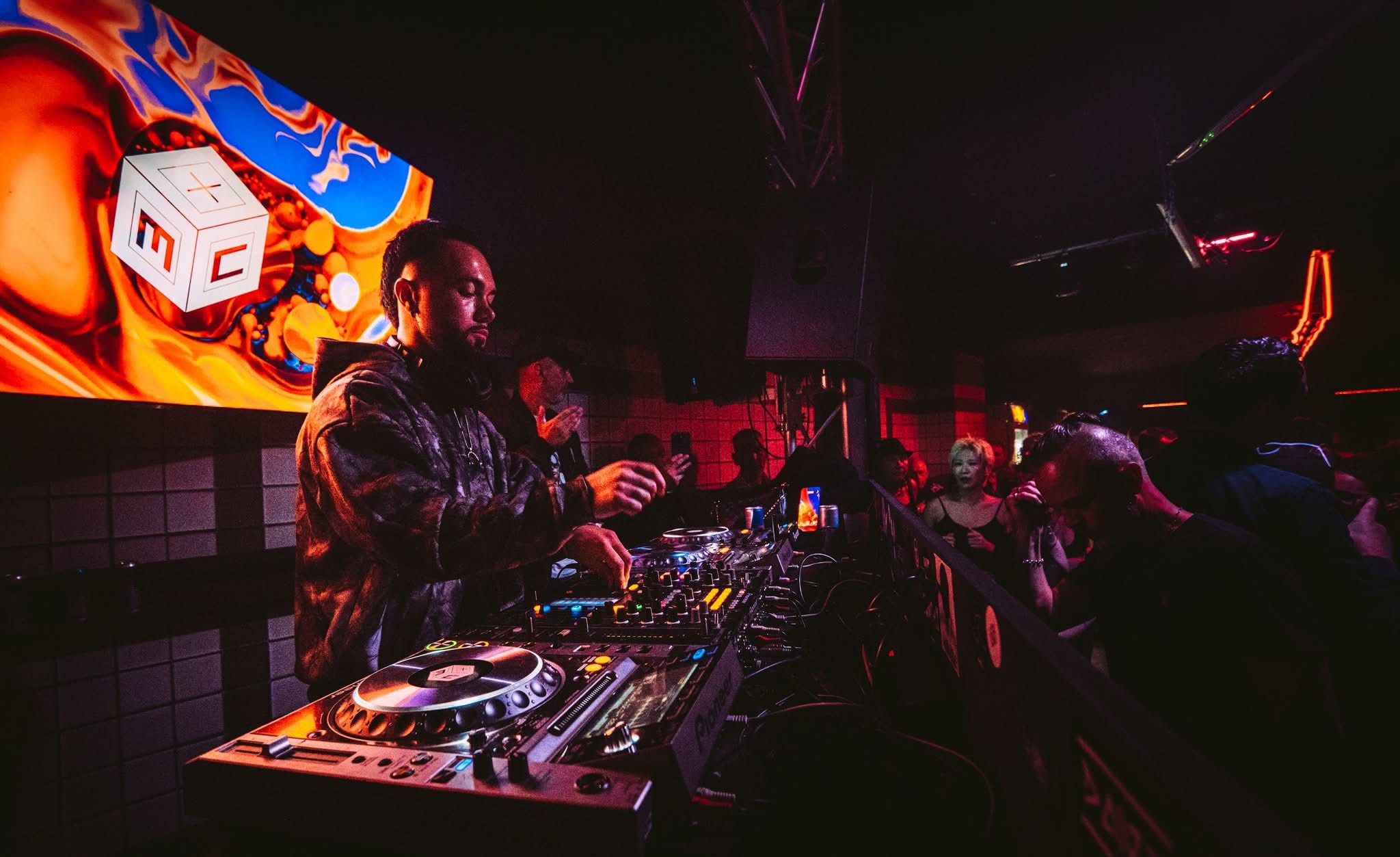 AARON H performing close to the crowd under warm stage lighting